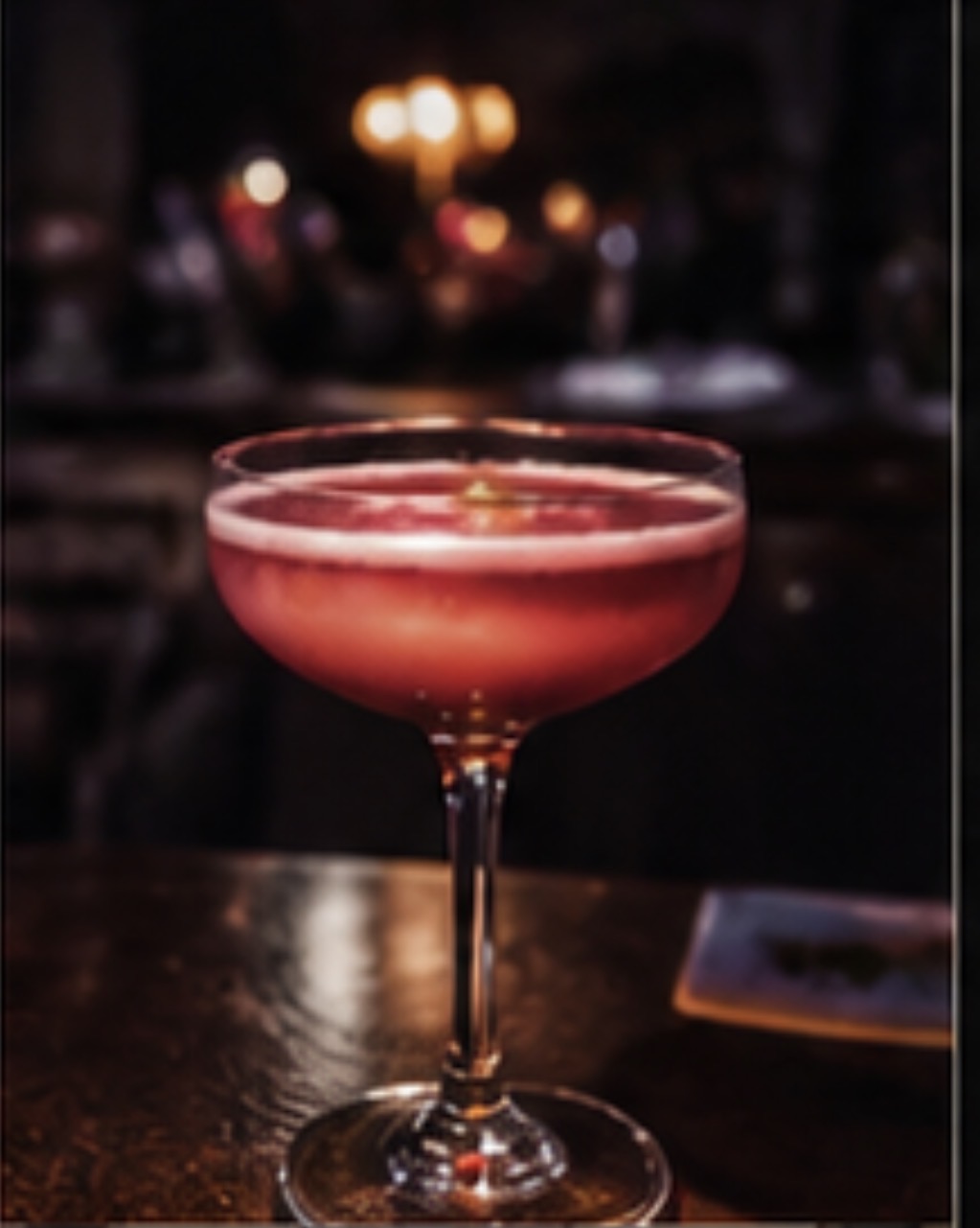 Pink cocktail in a dark New Orleans bar